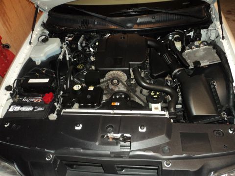 2004 Mercury Grand Marquis - The engine bay of a white vehicle is shown, with visible text indicating SUPERMOTORS.NET.