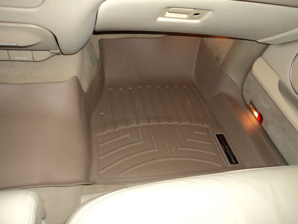 Tan WeatherTech floor mats in a vehicle interior