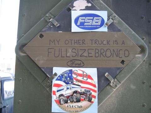 1981 Ford Bronco - A sign and stickers are affixed to a green metal surface, one sticker mentions 'FSB 1978-1996'.