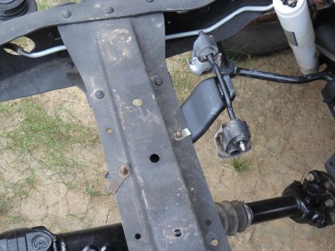 1993 Ford Bronco - Ford installs this hanger with a stud at the rear (right of image) & a nut on top of the crossmember. Then there's a loose bolt & nut at th…