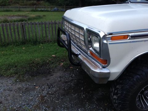 1979 Ford Bronco - Front view of a white 1979 Ford Bronco, a chrome grille and a black bull bar attached to the bumper.