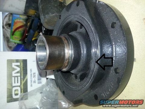 1994 Ford Bronco - A crankshaft pulley is shown, with an arrow indicating a specific groove on its surface.
