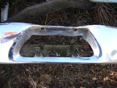 1973 Ford Ranchero - A close-up view of a chrome bumper part, showing its reflective surface and mounting holes.