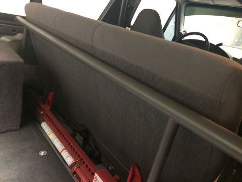 1995 Ford Bronco - Vehicle interior with roll cage and hi-lift jack visible.