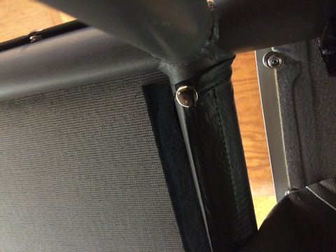 1995 Ford Bronco - Close-up of the interior structure and fabric of a vehicle, showing fasteners and a metal frame.