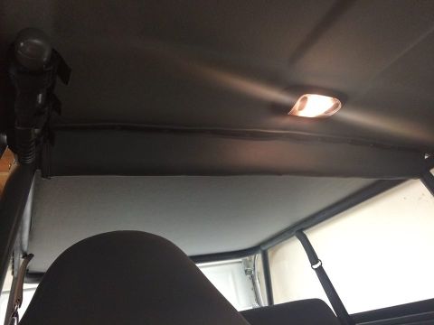 1995 Ford Bronco - View of the interior cage and headliner, including the dome light.