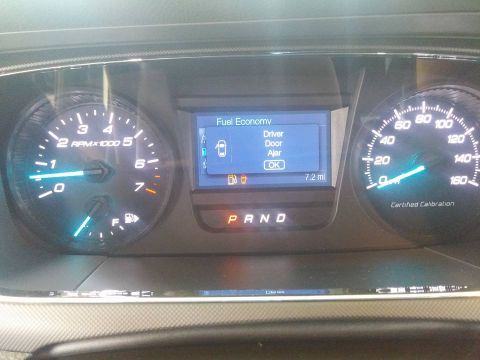 2000 Mercury Grand Marquis - The dashboard displays fuel economy information and alerts for open doors.
