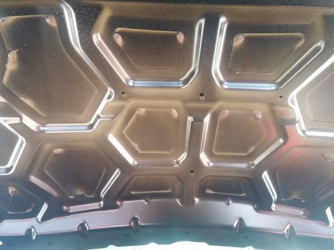 2000 Mercury Grand Marquis - Underside of a car hood with hexagonal and trapezoidal reinforcement patterns.