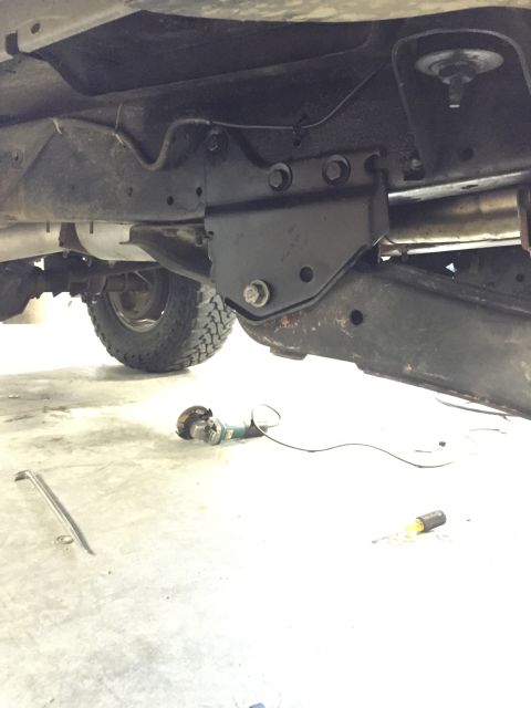 1984 Ford Bronco - Close-up view of a custom suspension component installed on a vehicle's undercarriage.