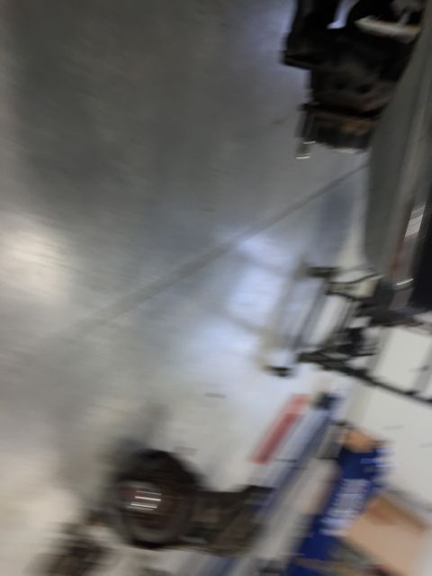 1984 Ford Bronco - The underside of a vehicle is visible, showing suspension parts and a watermark from Supermotors.net.