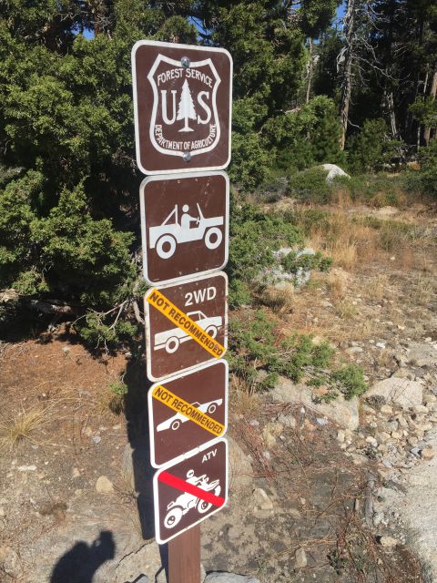 1989 Ford Bronco - A series of signs from the Forest Service Department of Agriculture indicates which vehicles are not recommended for the area.