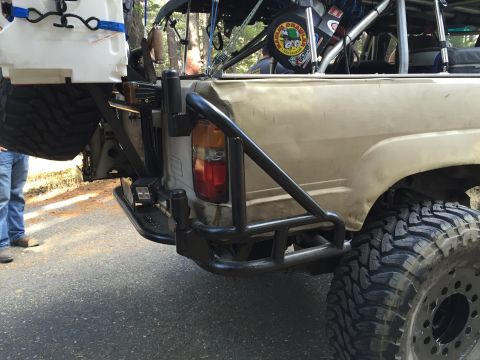 1989 Ford Bronco - This modified 1989 Ford Bronco features a custom rear bumper, roll cage, and spare tire mount, ready for off-road adventures.