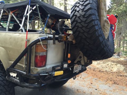 1989 Ford Bronco - Rear view of a modified 1989 Ford Bronco equipped for off-road adventures with camping gear.
