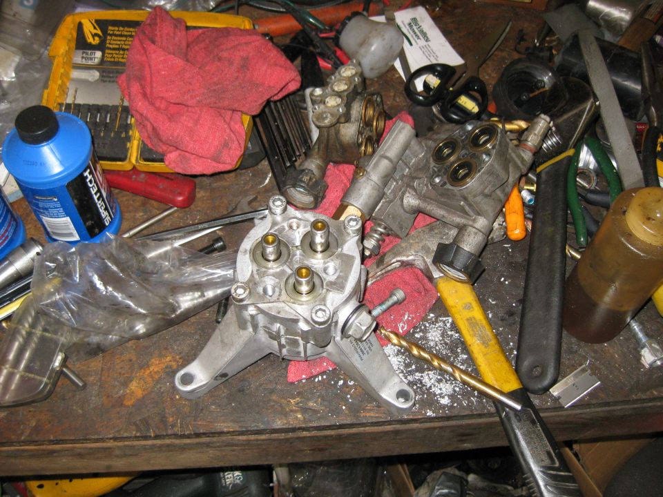 Pressure washer pump parts and tools on a workbench