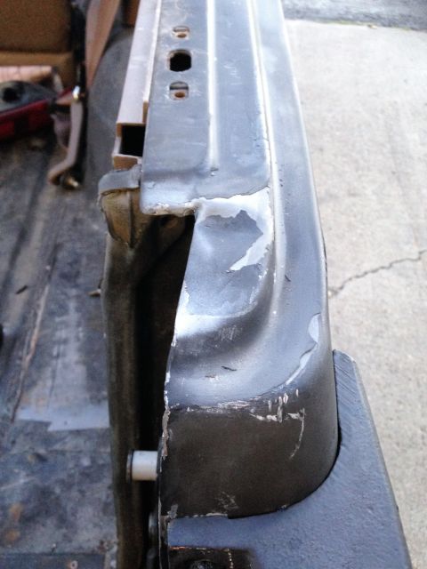 1992 Ford Bronco - Damaged door edge with visible primer and chipped paint.