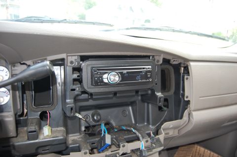 1994 Ford Bronco - The interior of a vehicle shows a JVC car stereo installed in the dashboard, with wiring exposed below. The dashboard is partially disassem…