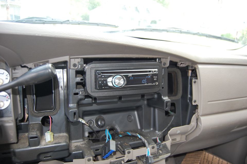 JVC car stereo installed in a partially disassembled vehicle dashboard.