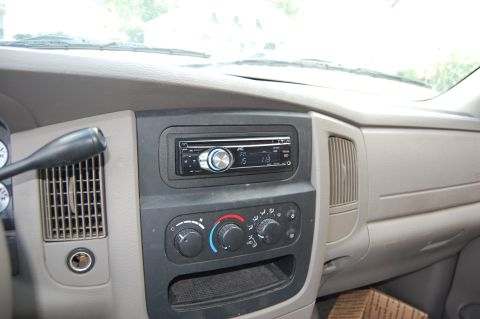 1994 Ford Bronco - The interior of a vehicle dashboard shows a JVC car stereo and climate controls. A gear shifter is visible to the left of the stereo.