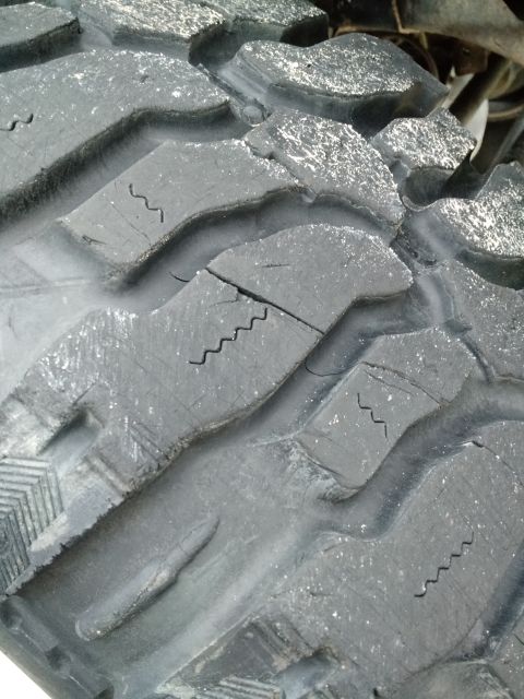 1992 Ford Bronco - Tire tread shows significant cracking and wear, indicating age and use.