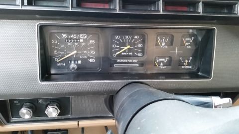 1981 Ford Bronco - The image shows a close-up view of a vehicle's dashboard, focusing on the instrument cluster. Visible gauges include the speedometer, tacho…