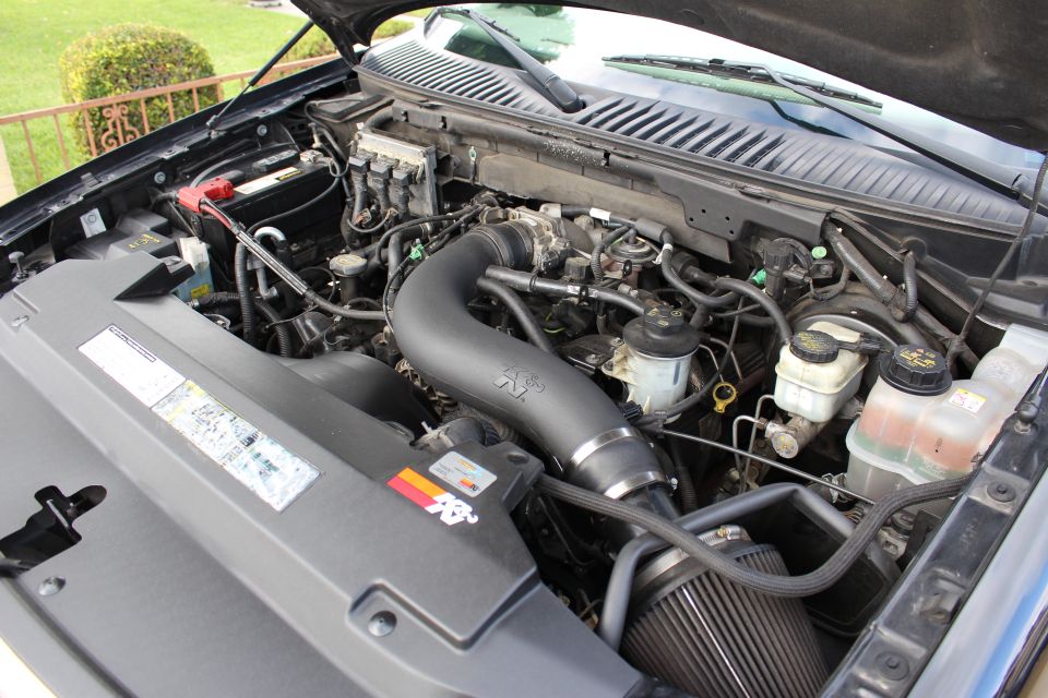 Engine bay of a dark Ford Expedition with K&N intake.