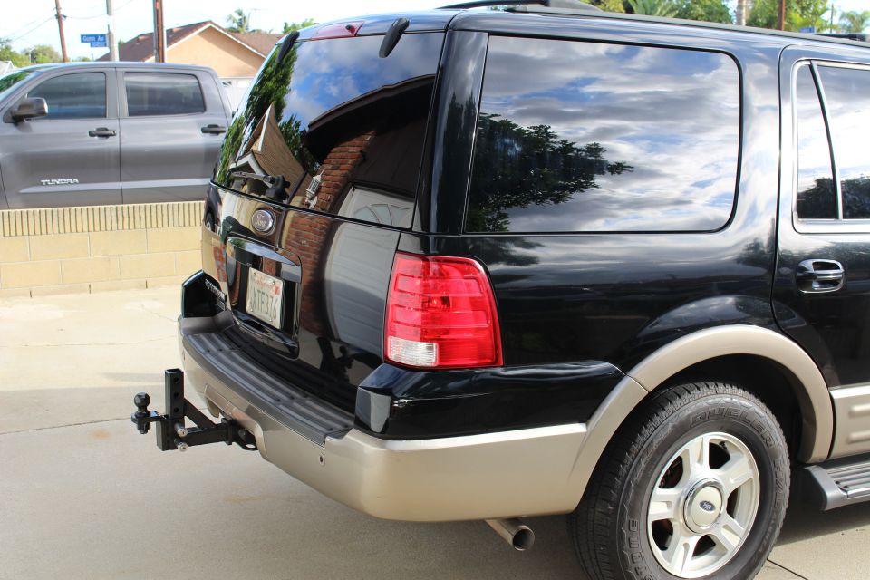 Black 2003 Ford Expedition rear driver side with trailer hitch and license plate