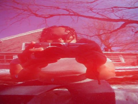 1997 Ford Taurus - Reflection of a person holding a camera on the hood of a red car.