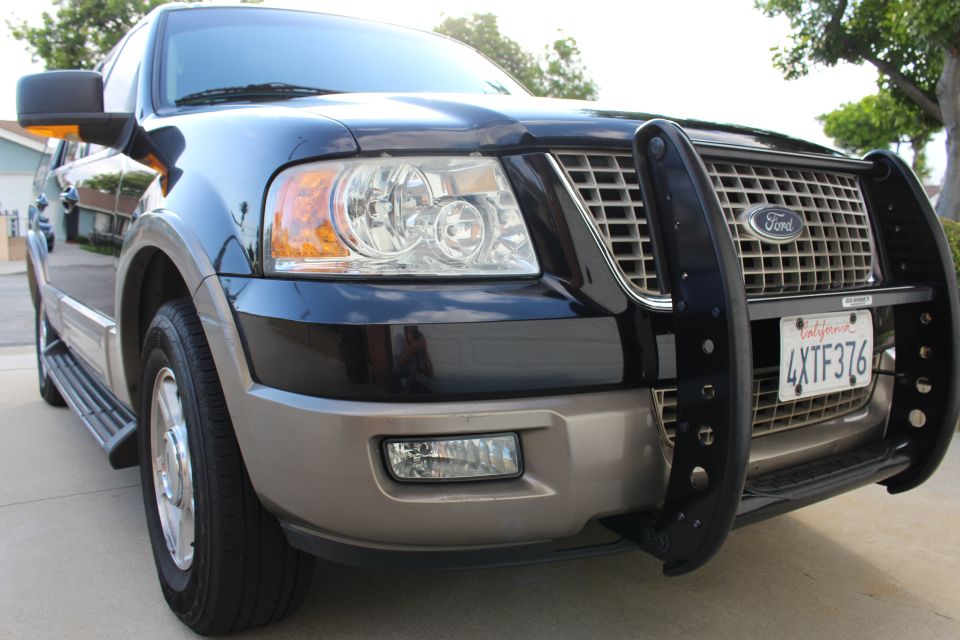 Black and tan 2003 Ford Expedition front view with brush guard and California license plate 4XTF376