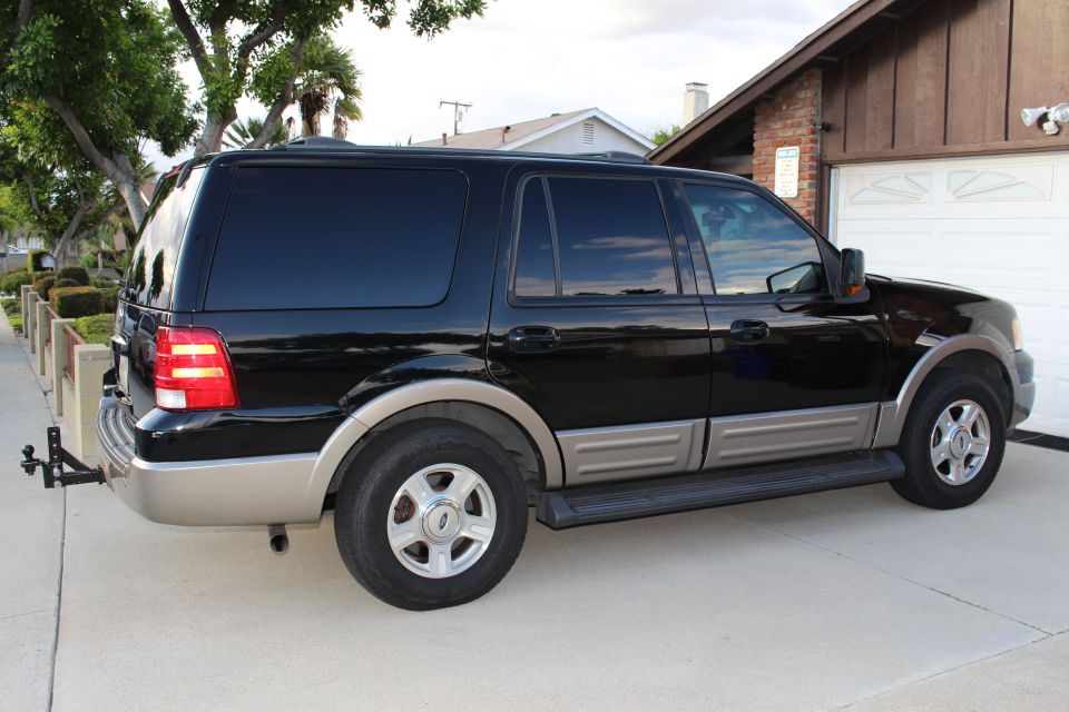 Side view of a black 2003 Ford Expedition parked in a driveway