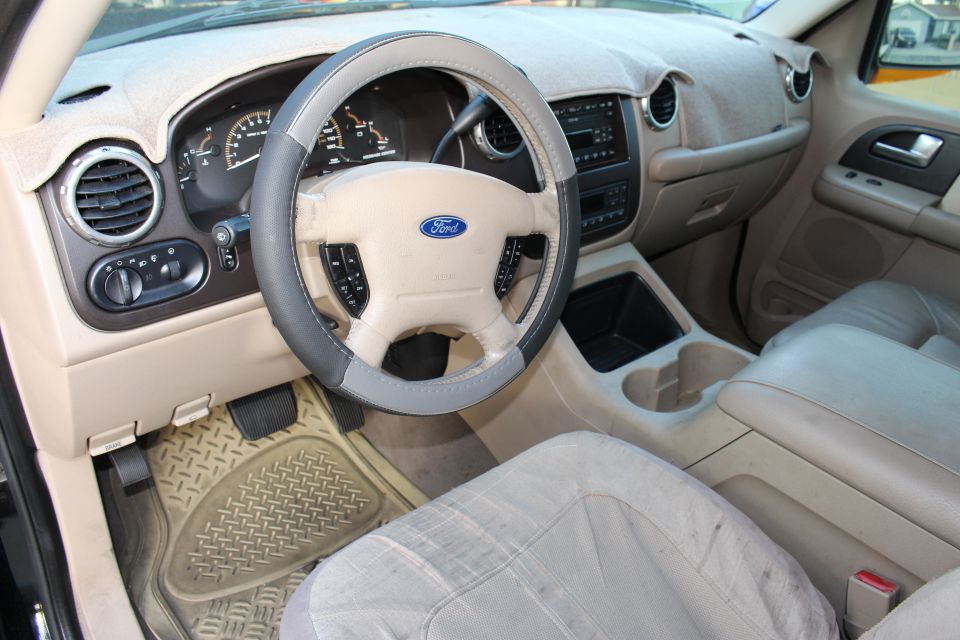 2003 Ford Expedition interior showing dashboard, steering wheel, and seats