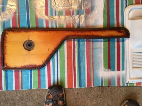 1978 Ford Bronco - A single car door panel is laid out on a colorful striped blanket, showing signs of wear and rust.
