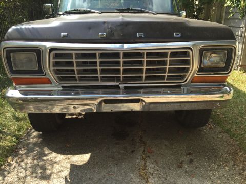 1978 Ford Bronco - Front view of a dark colored Ford truck, showing the grille and bumper details.
