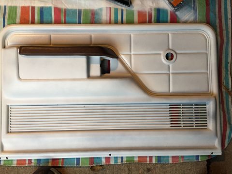 1978 Ford Bronco - Interior door panel from a 1978 Ford Bronco, showing the armrest and speaker grille.