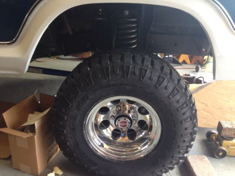 1978 Ford Bronco - Close-up of the wheel and suspension of a 1978 Ford Bronco, showing off-road tire and chrome rim.