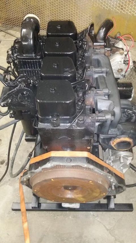 1994 Ford Bronco - A black diesel engine is mounted on a stand, showing its various components and connections.