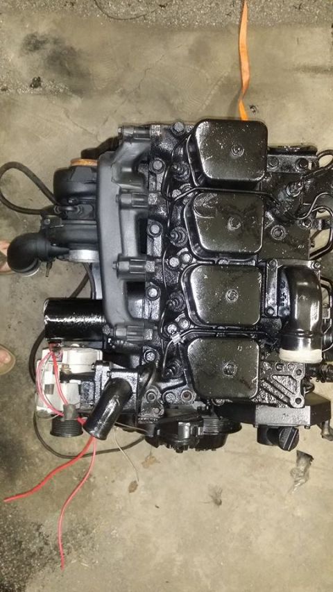 1994 Ford Bronco - This is a black engine with four valve covers and an alternator.