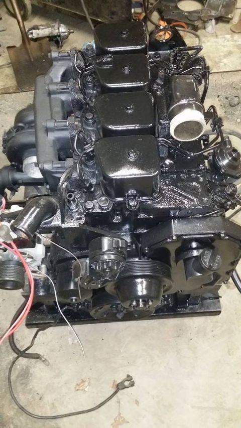 1994 Ford Bronco - A black engine, likely a diesel, is shown with its various components and wiring.