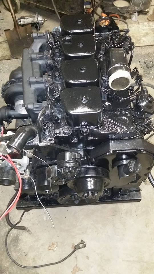 Black engine with visible fuel injectors and pulleys