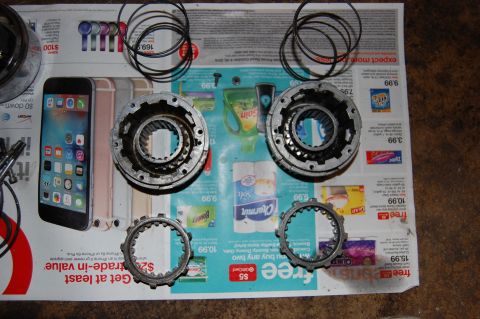 1994 Ford Bronco - Transmission clutch pack components and O-rings are laid out on a newspaper for inspection.