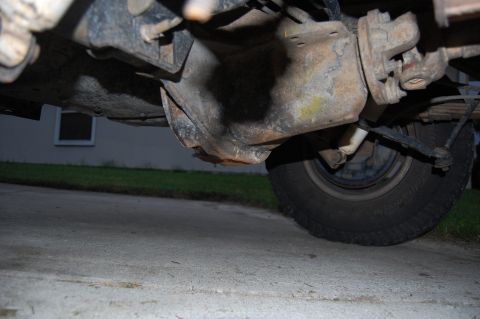 1994 Ford Bronco - The underside of a vehicle reveals significant rust on the differential and suspension components.