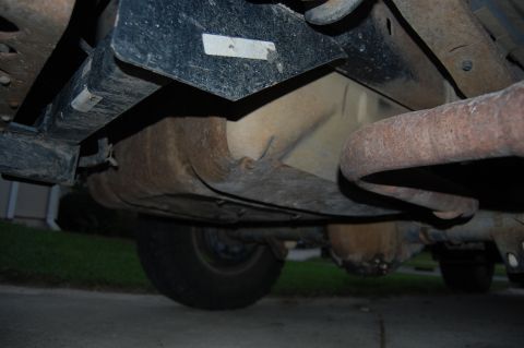1994 Ford Bronco - The underside of a 1994 Ford Bronco reveals its exhaust system and fuel tank, with visible signs of wear and tear.