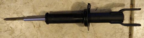 1993 Ford Thunderbird - A single automotive shock absorber is shown against a textured background.