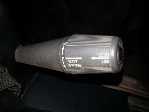 1994 Ford Bronco - Close-up of a vehicle's cruise control stalk, showing operational labels.