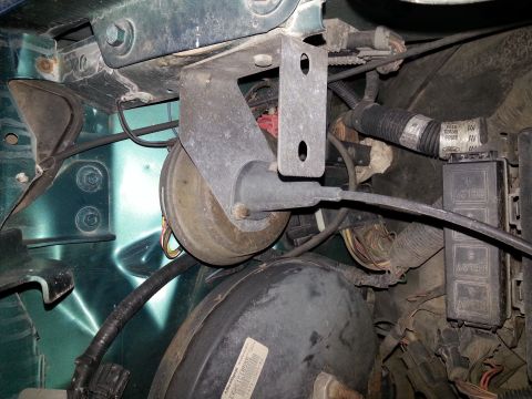 1994 Ford Bronco - This image shows the brake booster and associated wiring within a vehicle's engine compartment.