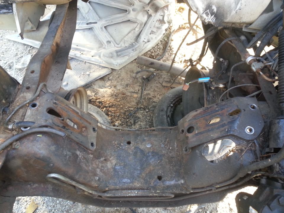 rusted vehicle frame with suspension components and wiring