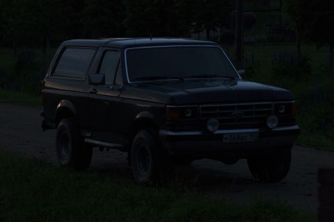 1987 Ford Bronco - This 1987 Ford Bronco is seen from a 3/4 front angle on a dirt road as daylight fades.