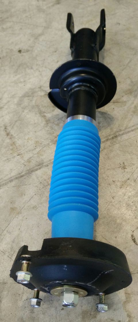 1993 Ford Thunderbird - A car shock absorber part is shown against a concrete floor. Text at the bottom reads "SUPERMOTORS www.supermotors.net".