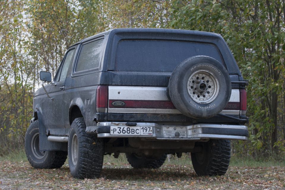 Rear view of a dark gray 1987 Ford Bronco with a spare tire mounted externally
