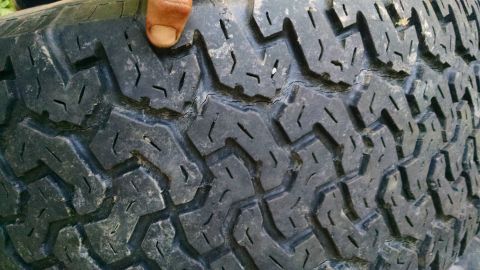 1994 Ford Bronco - A close-up view of a tire's tread pattern, showing wear and tear.