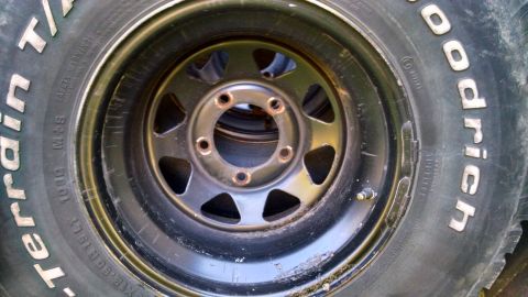 1994 Ford Bronco - Close-up of a BFGoodrich All-Terrain T/A tire mounted on a black steel wheel.